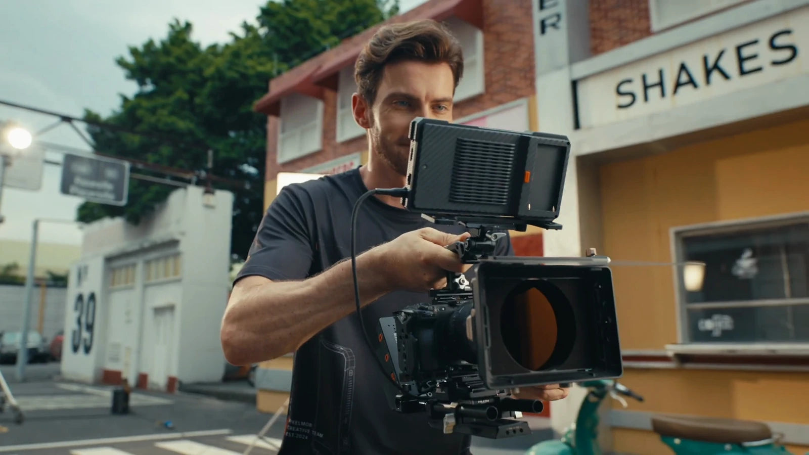A filmmaker using PixelMob mounted above the camera rig on a street set